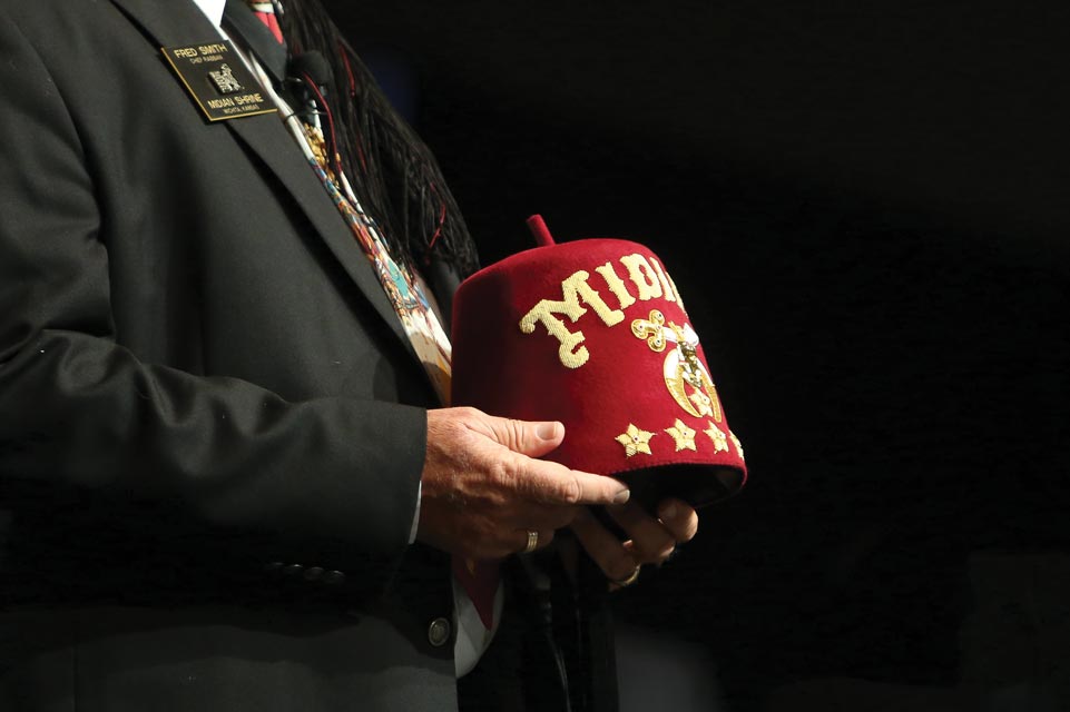 A man prominently displaying a red fez