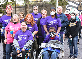 Shriner und Familienmitglieder in lila Shorts bei einem Walk-Event