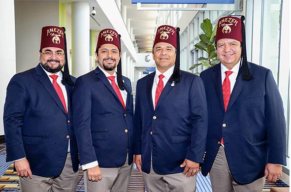 four shriners standing together in exhibt hall