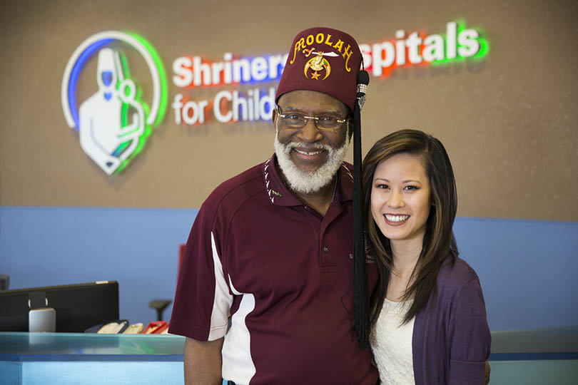 shriner standing with patient