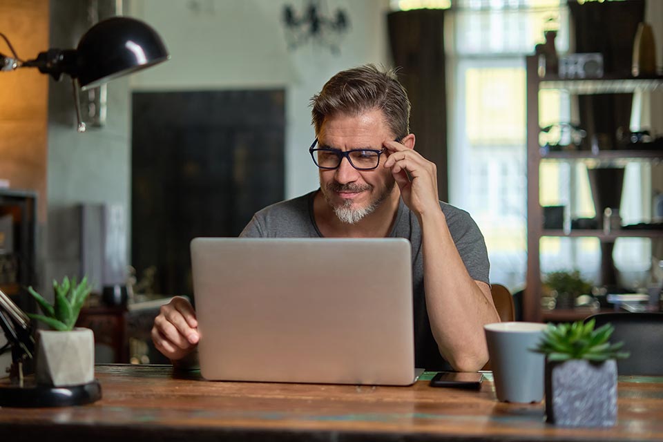 Man looking at laptop screen