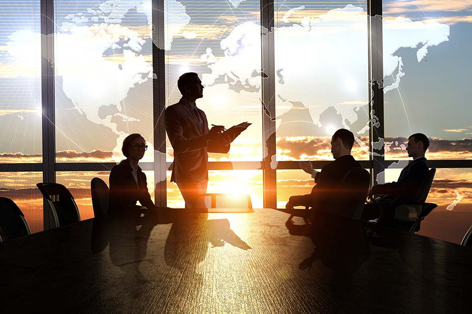four adults meeting in conference room