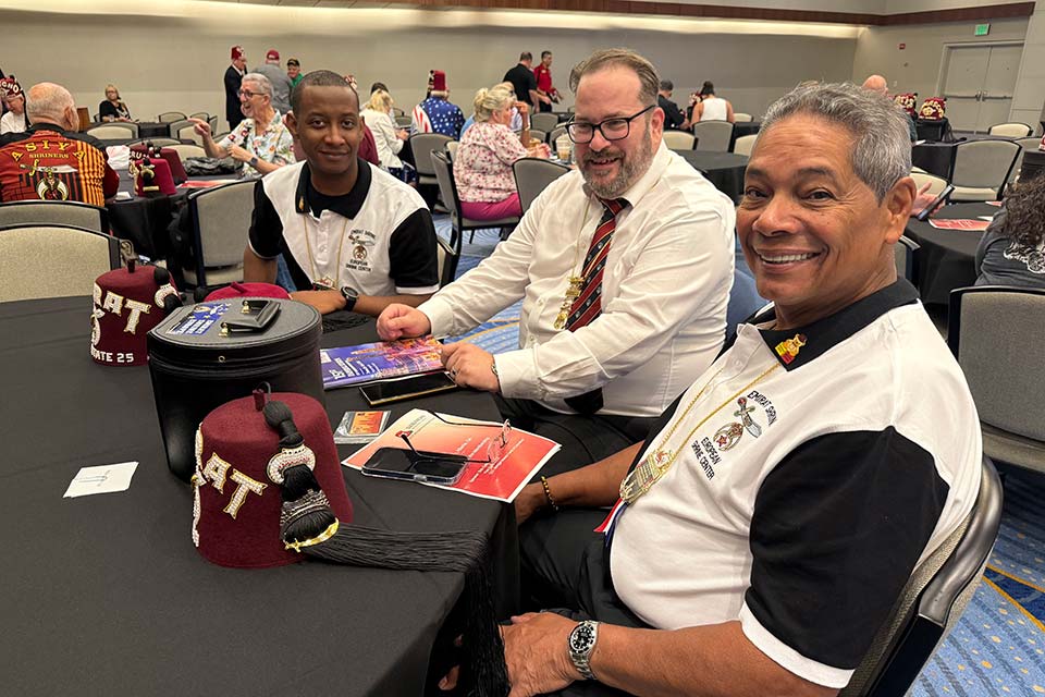 three Shriners at meeting