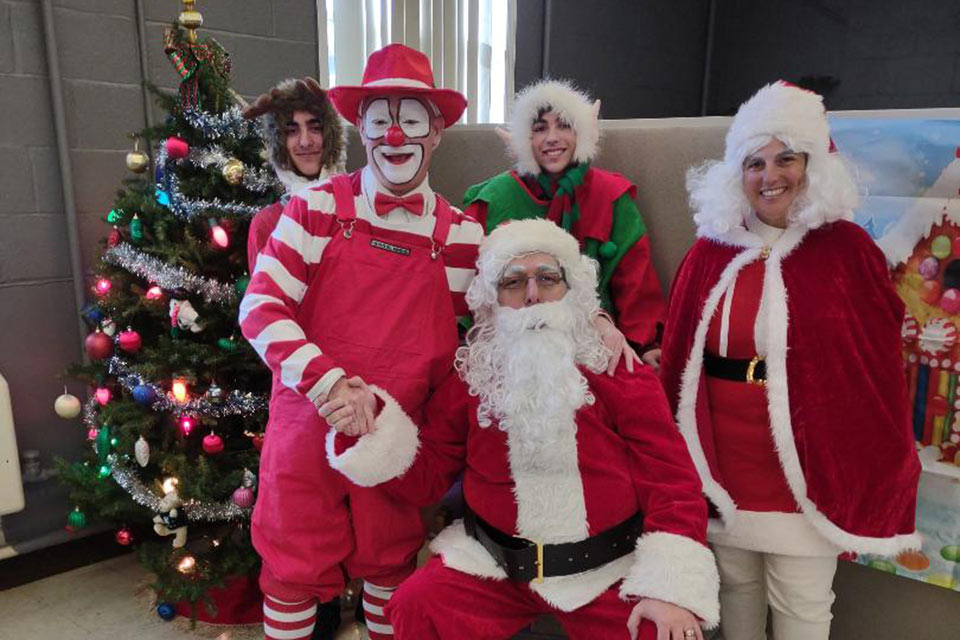 Santa, Mrs. Claus, a clown and two elves