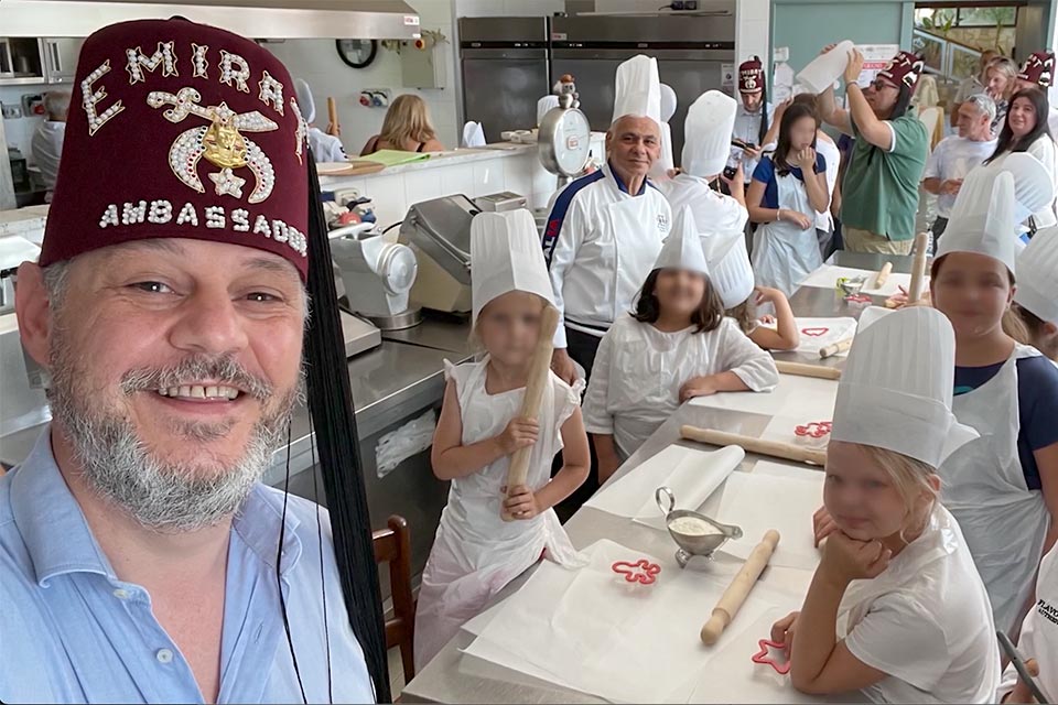 Shriner leading children during cooking class