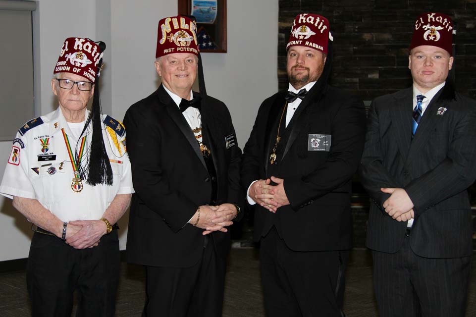 Four Shriners standing with hands clasped