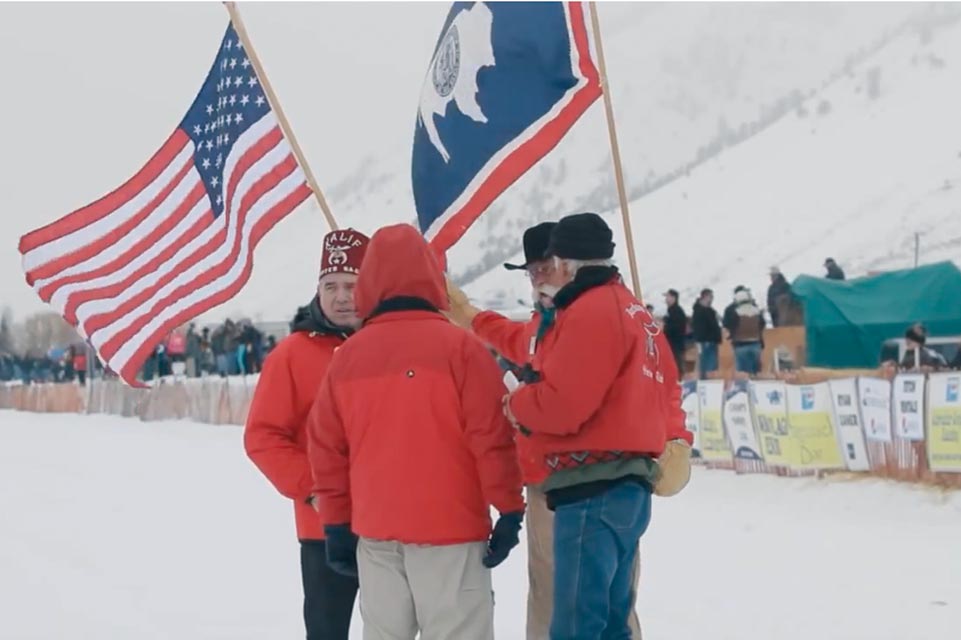 shriners standing with flags behind them