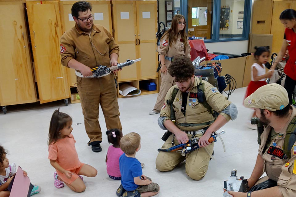 mean wearing Ghostbusters costumes a nd several children
