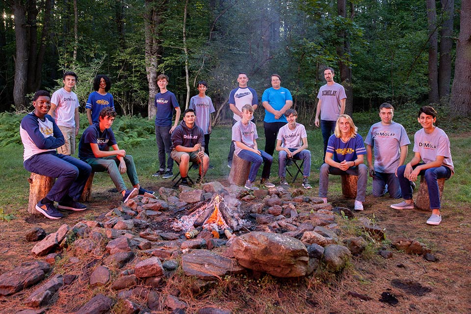 DeMolay members around large campfire