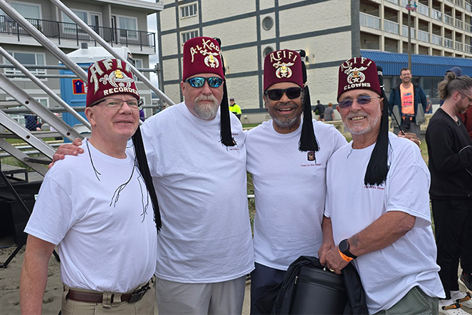 four men in white shirts and fezzes