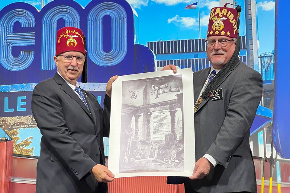 Two Acrux Shriners presenting a poster