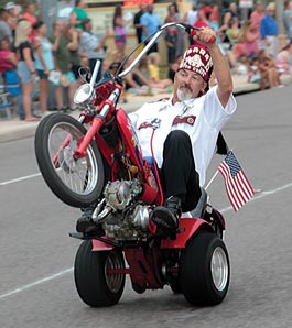 Shriner driving tiny motorcycle