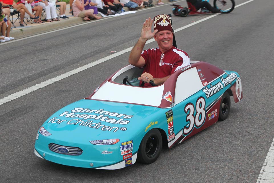 Shriner driving tiny car