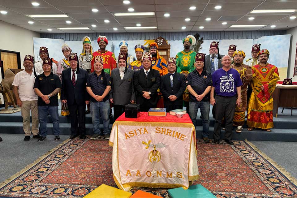 Patrick Adair pose pour une photo de groupe avec les Asiya Shriners.