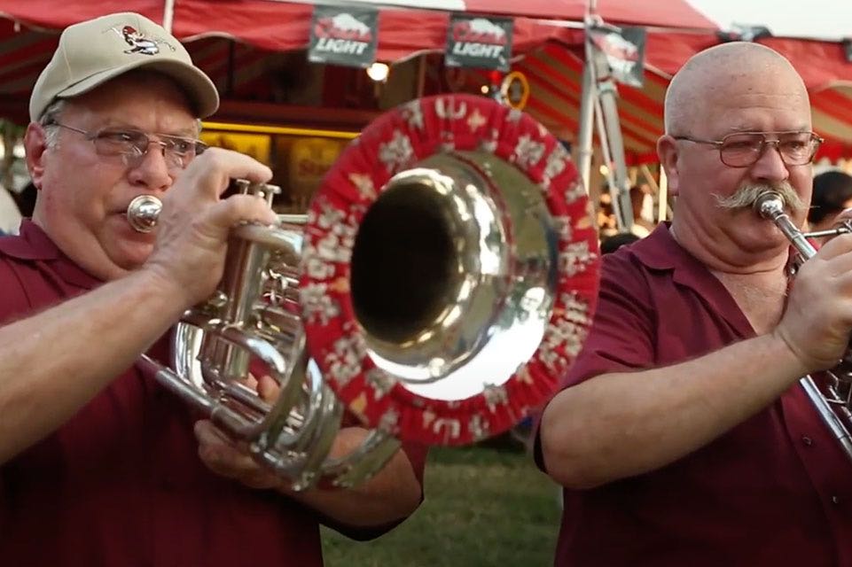 Two men playing trumpets 