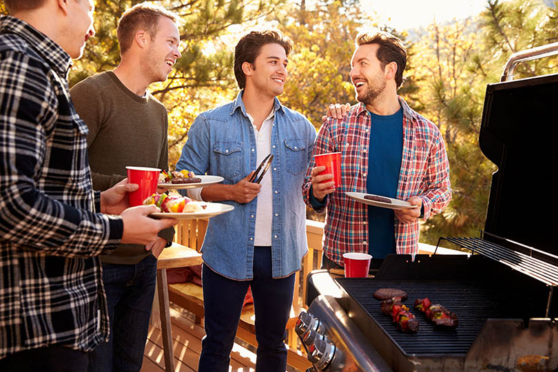 image of young men grilling
