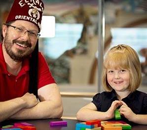 shriner with patient helping