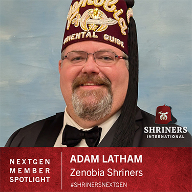 Shriners International logo;  NEXTGEN MEMBER SPOTLIGHT; ADAM LATHAM; Zenobia Shriners; #SHRINERSNEXTGEN; A man in a suit and tie wearing a fez that reads "Zenobia Oriental Guide." 